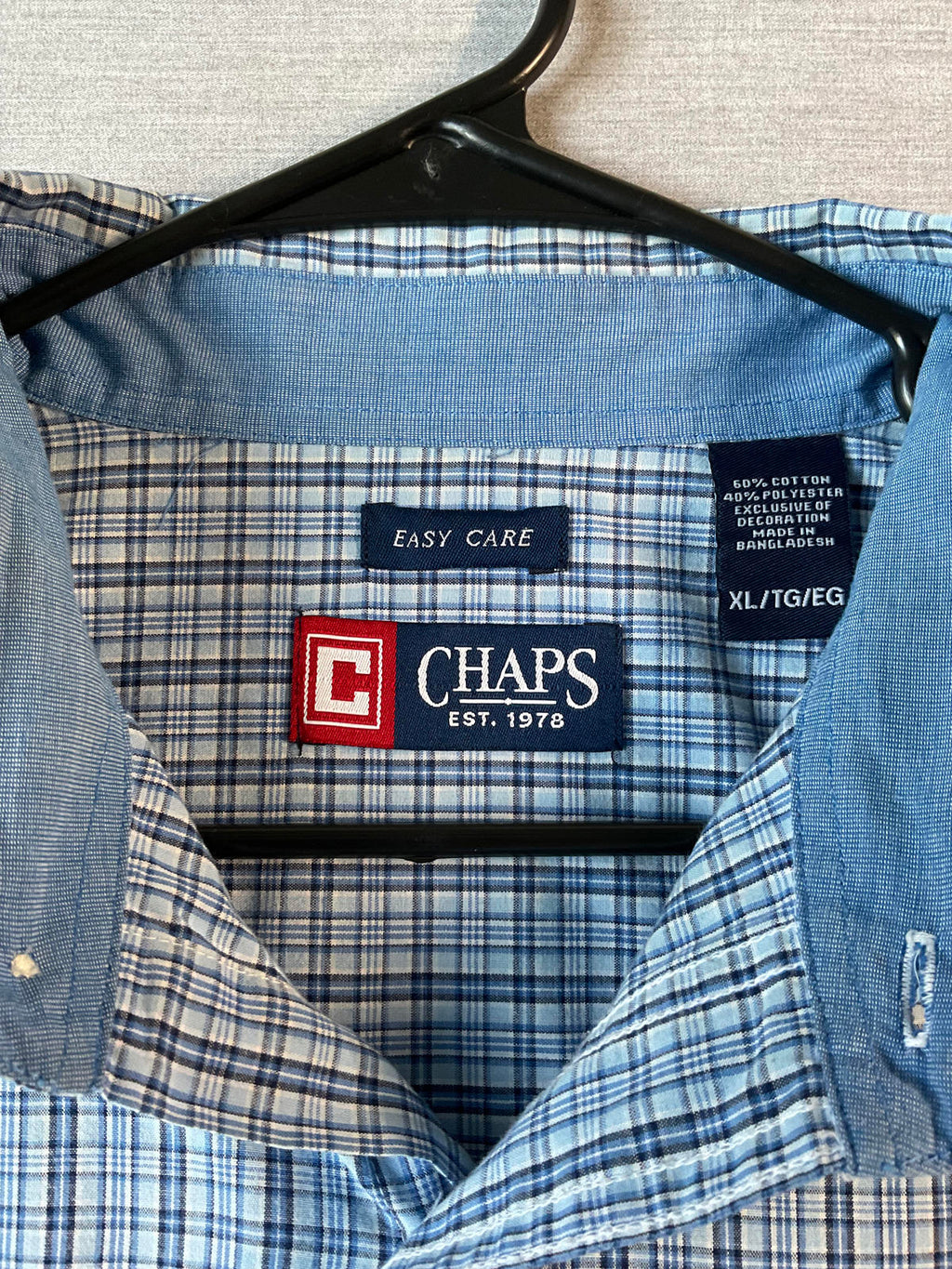 Blue checkered shirt with Chaps label on a hanger