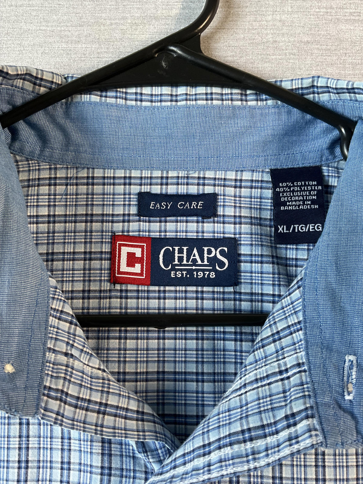 Blue checkered shirt with Chaps label on a hanger
